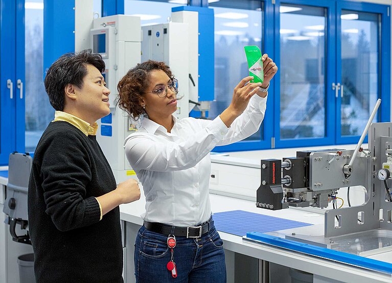 Colleague and customer conducting experiments for packaging