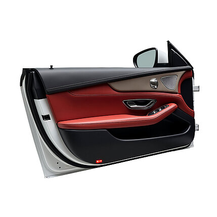 Car door interior with black and red leather and integrated control elements