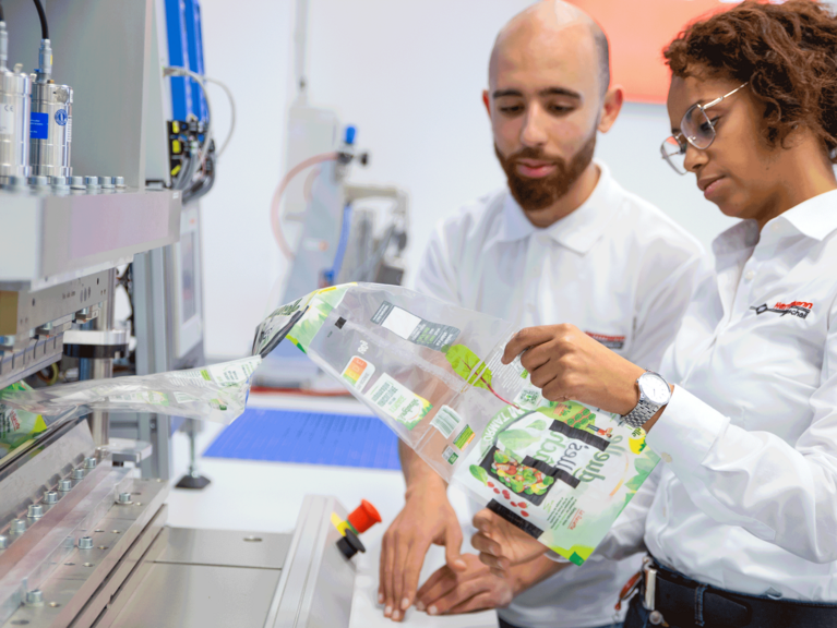 Colleagues conducting experiments in the application laboratory to reduce waste in food packaging